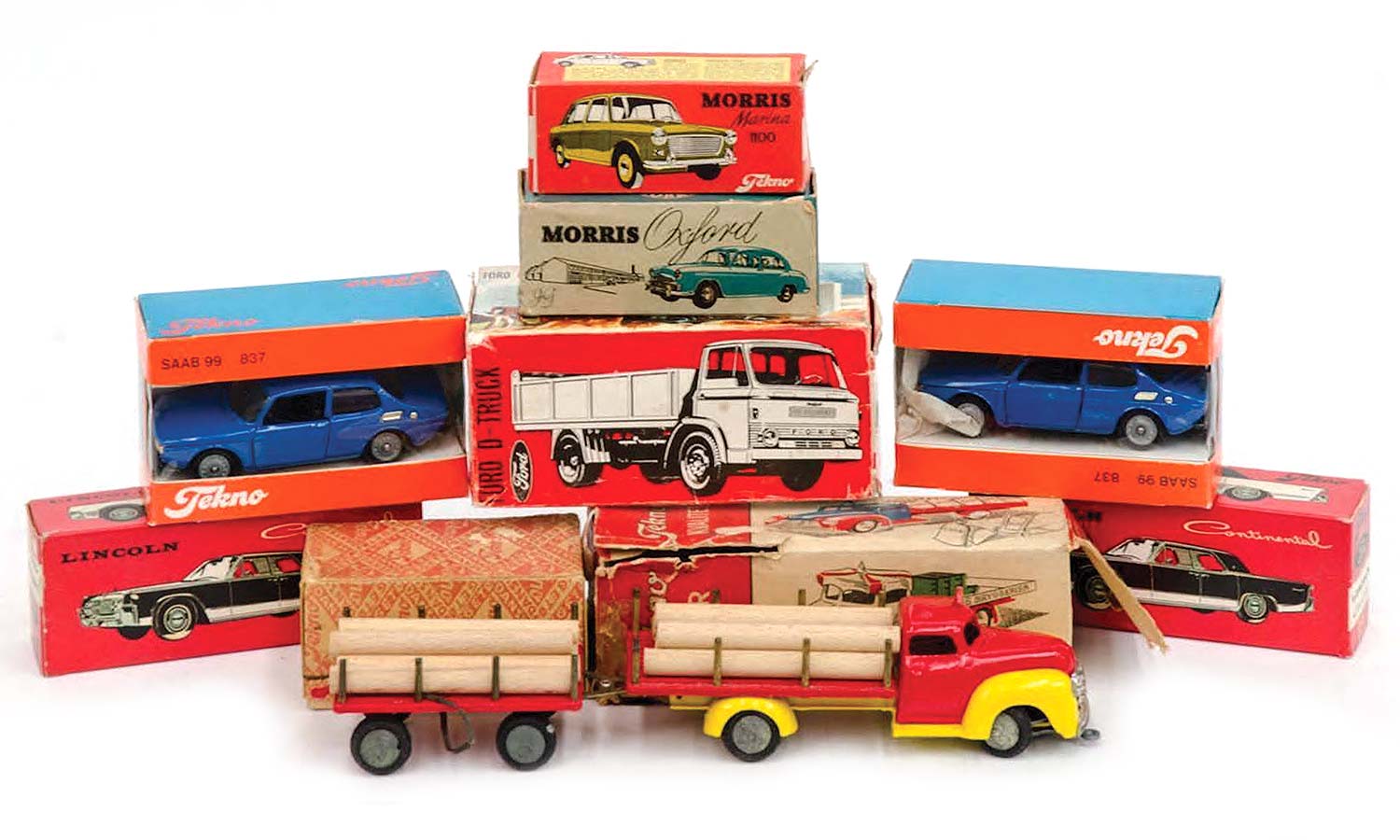 Group of 9 vintage Tekno model cars and trucks including a Dodge lumber truck with accompanying lumber truck trailer, a Morris Marina 1100 and a Ford D truck. Sold for $225 at Leski Auctions, Melbourne.