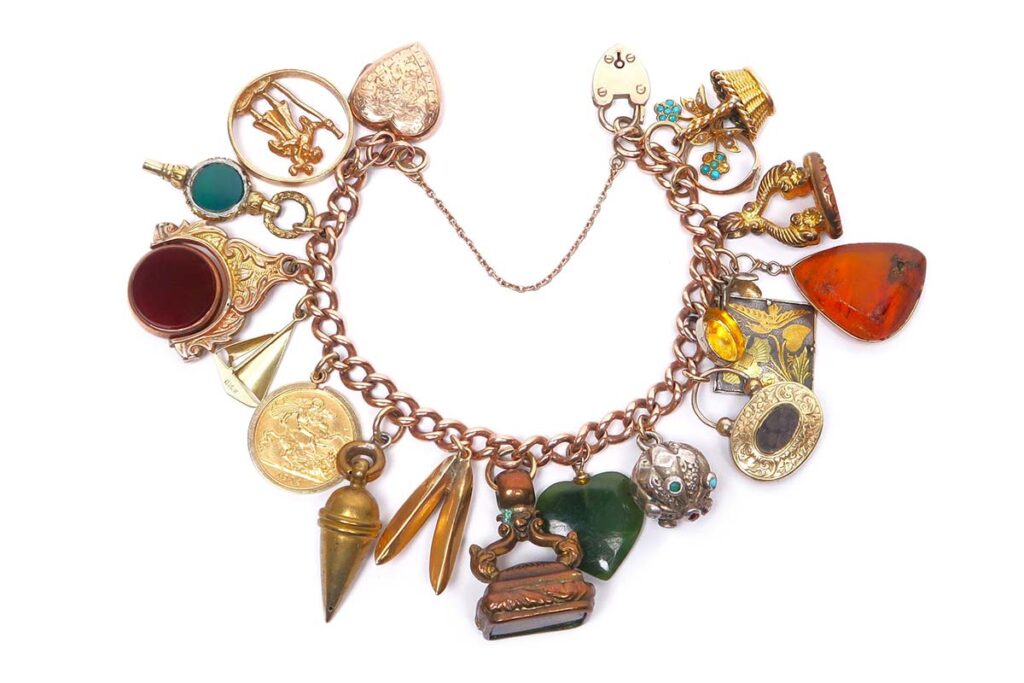 14ct Rose Gold Charm Bracelet with Charms including 14ct Gold Victorian Mourning Token 10ct Gold Childs Ring and 22ct Gold 1914 Half Sovereign in Vintage Box at Theodore Bruce auction