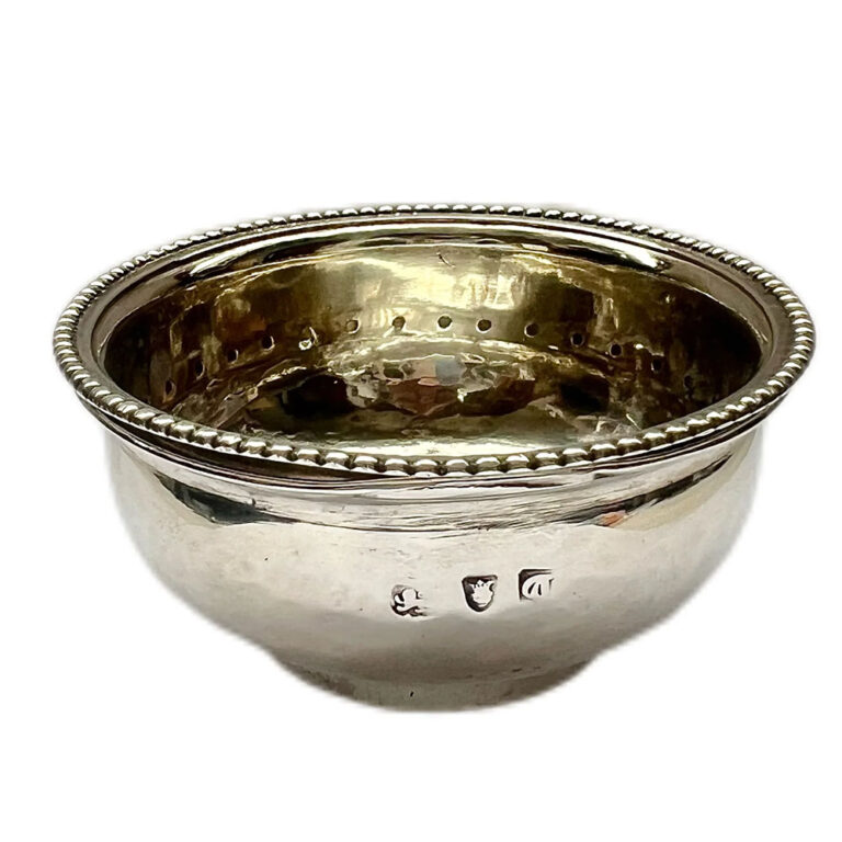 A rare and curious George III silver wine strainer