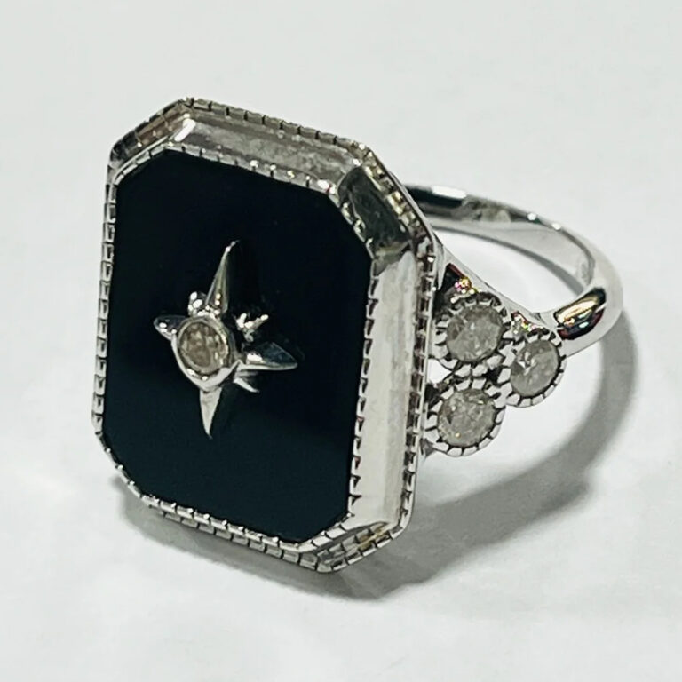 14ct white gold, black onyx and diamond ring