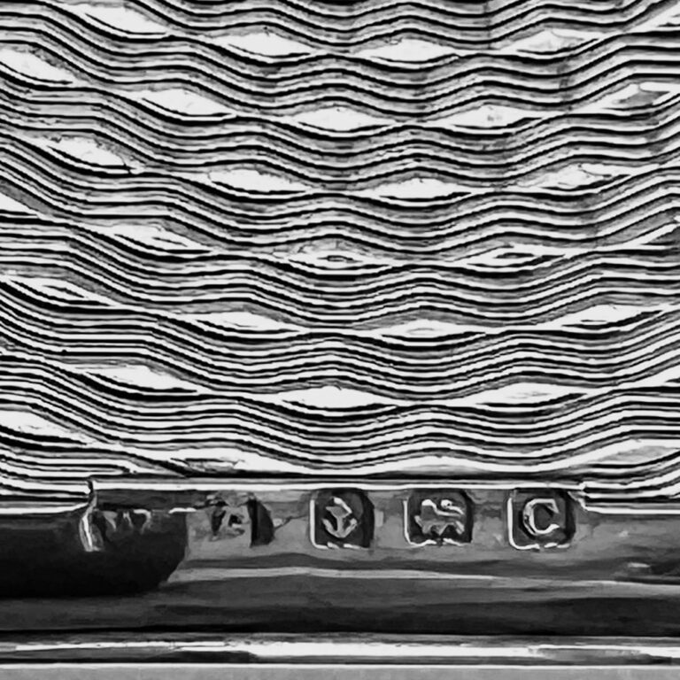 sterling silver hipflask with a finely engine-turned spiralling design