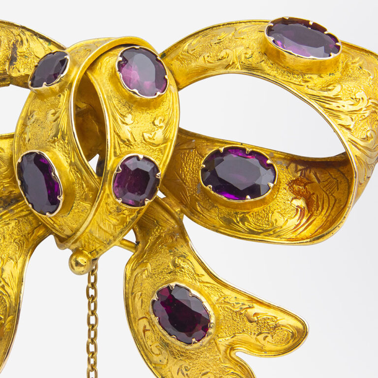 Australian gold and garnet bow brooch