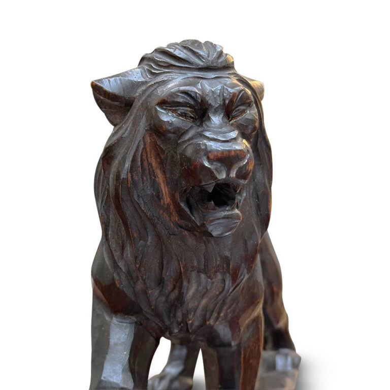 Ebonised carved lion figure