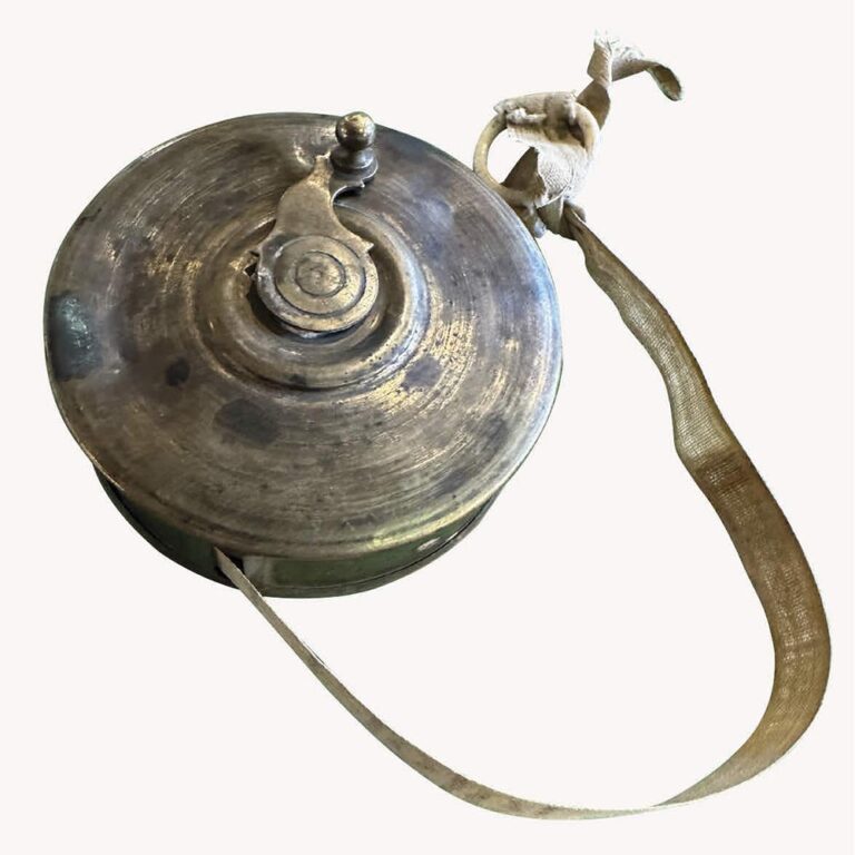A French brass and cloth tape measure.