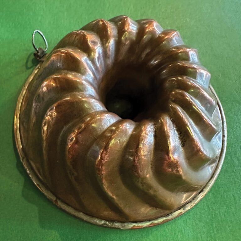 An antique copper miniature Bundt pan