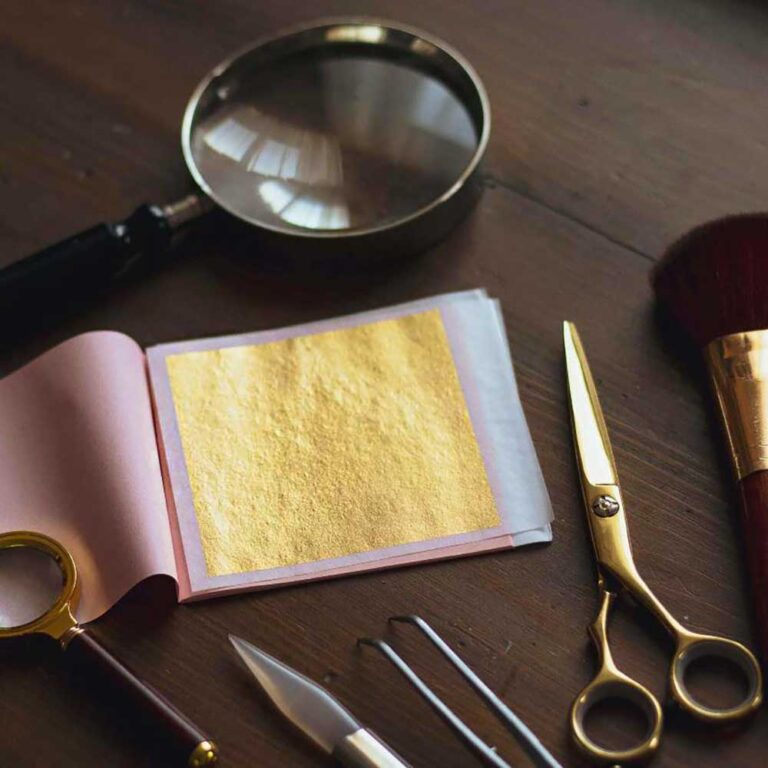 art gilding gold leaf squares in a book