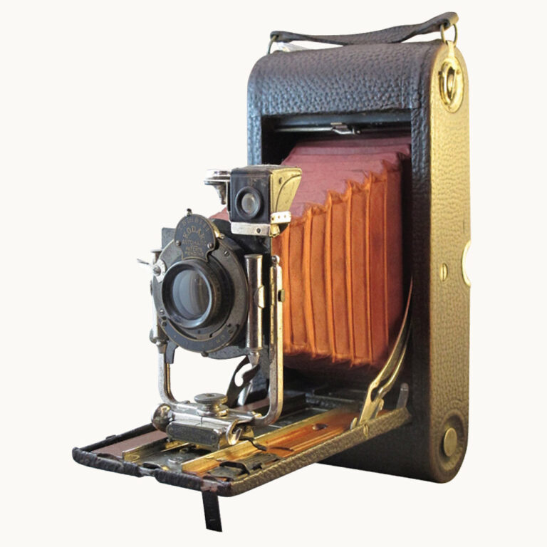Folding Kodak vintage camera with red bellows and timber tray