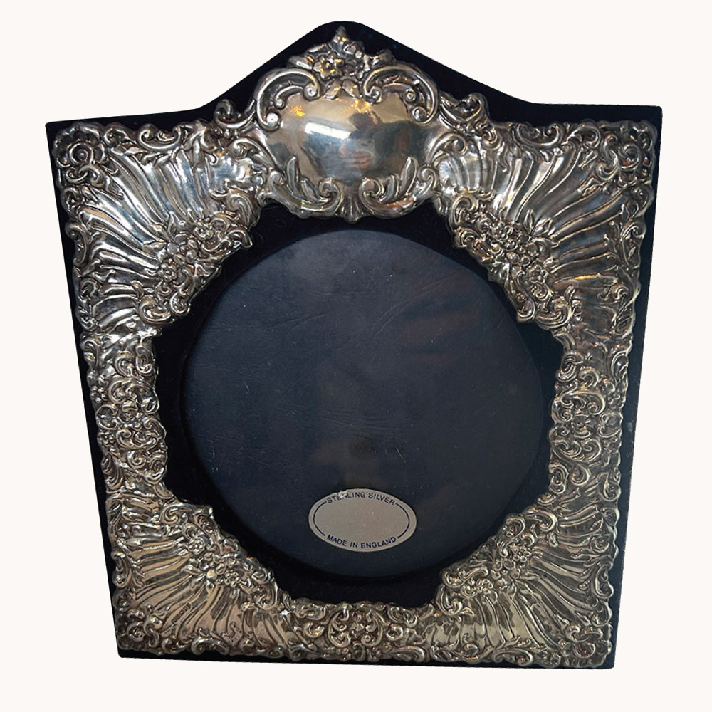 Contemporary English embossed sterling silver frame.