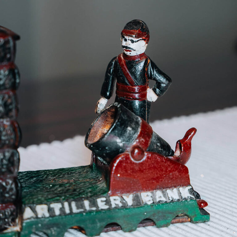 An antique mechanical ‘Artillery Bank’ cast iron money box