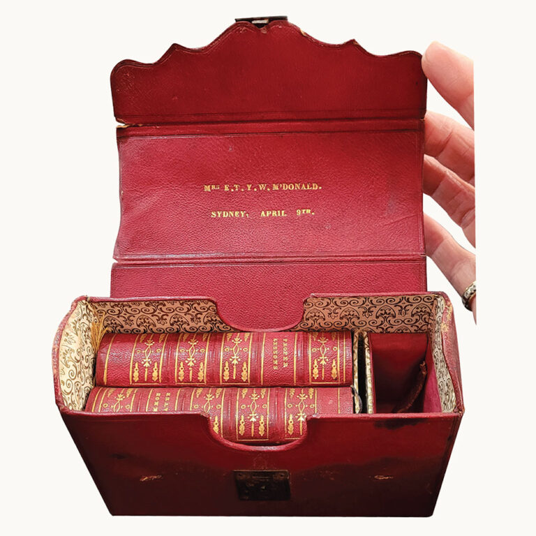 pair of miniature books in leather case