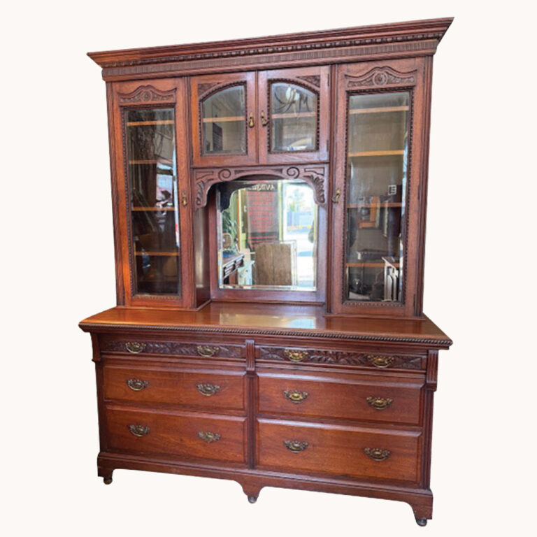A Victorian sideboard in carved walnut with a mirror back.