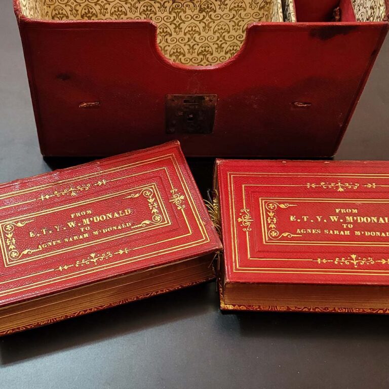 pair of miniature books in leather case
