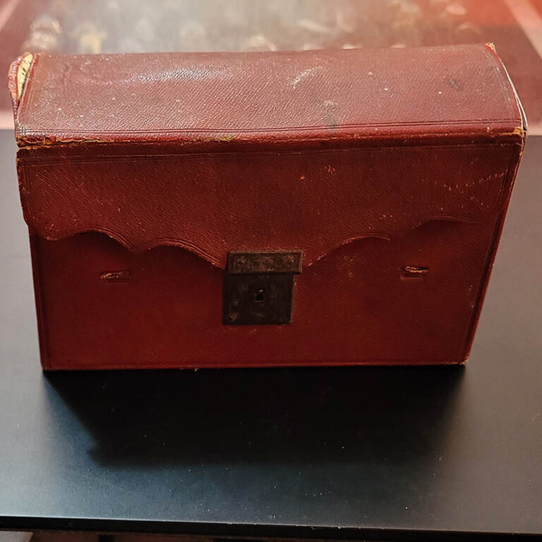 pair of miniature books in leather case
