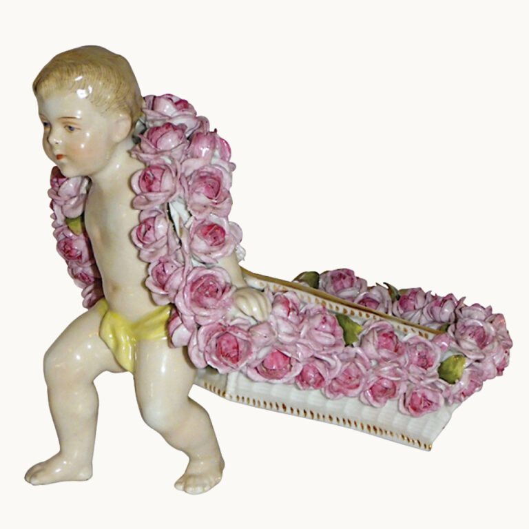 Plaue Schierholz porcelain figurine, a hand painted cherub pulling a floral cart