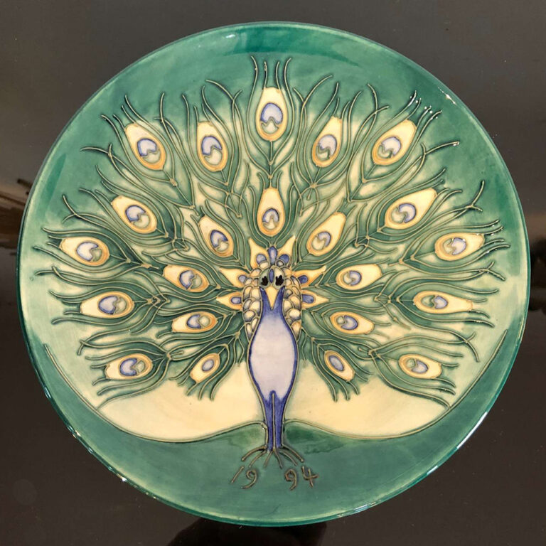 Moorcroft pottery plate with an elegant peacock
