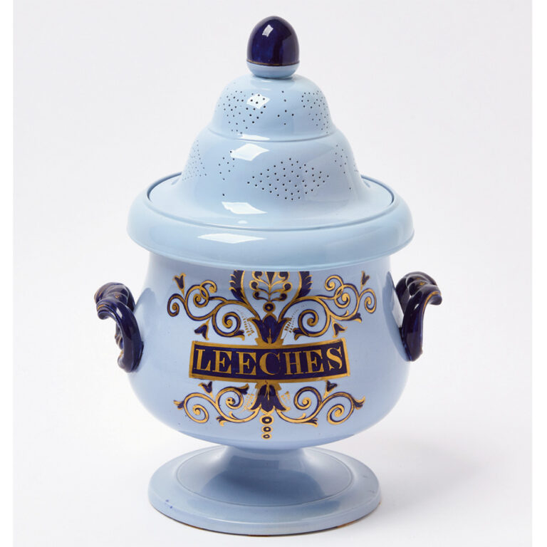 A pale blue glazed leech jar with gilt lettering and decoration