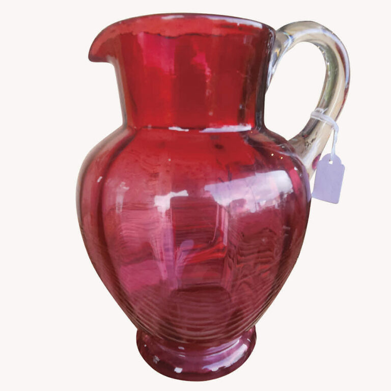 Ruby glass jug with clear glass handle.