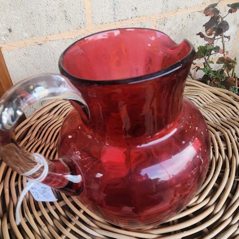 Ruby glass jug with clear glass handle.