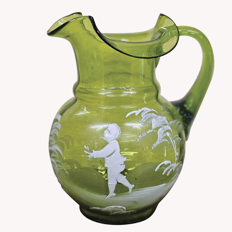 A beautiful Mary Gregory green glass jug, standing 16cm tall.