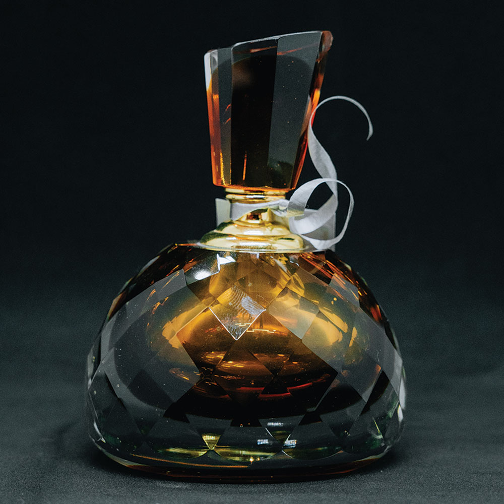 Large faceted amber glass perfume bottle