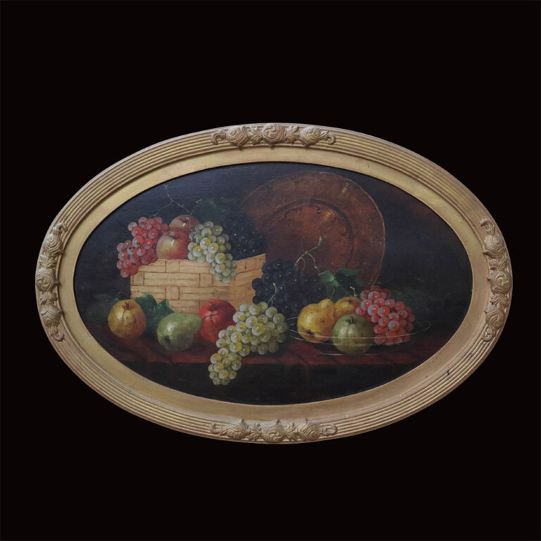 An oval still life painting of fruit with a gilt frame.