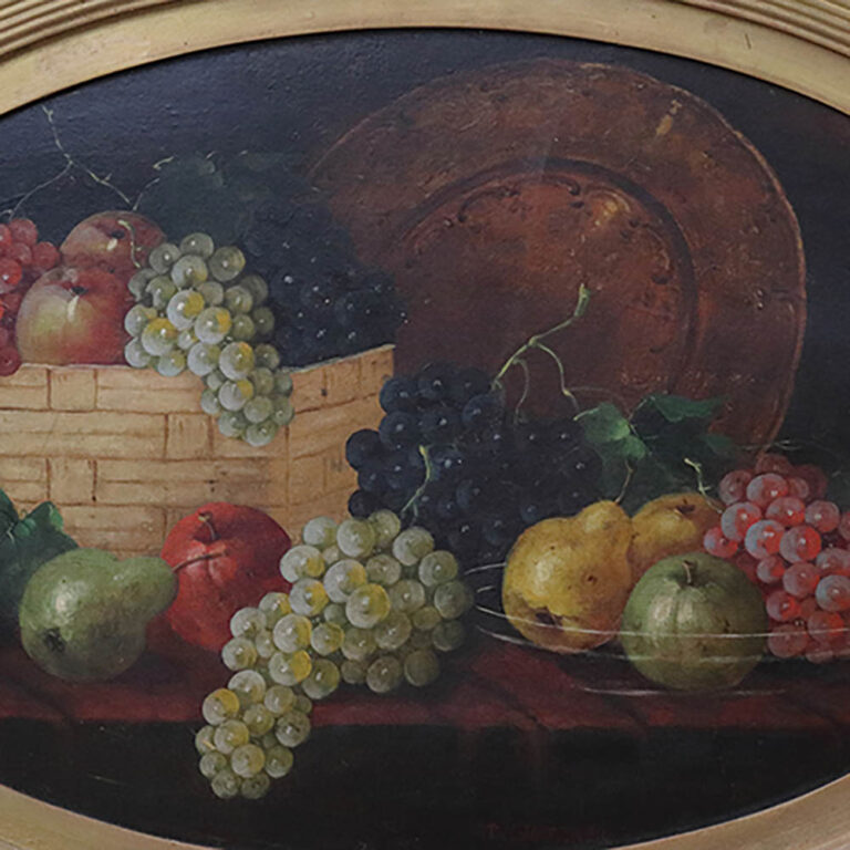 An oval still life painting of fruit with a gilt frame.