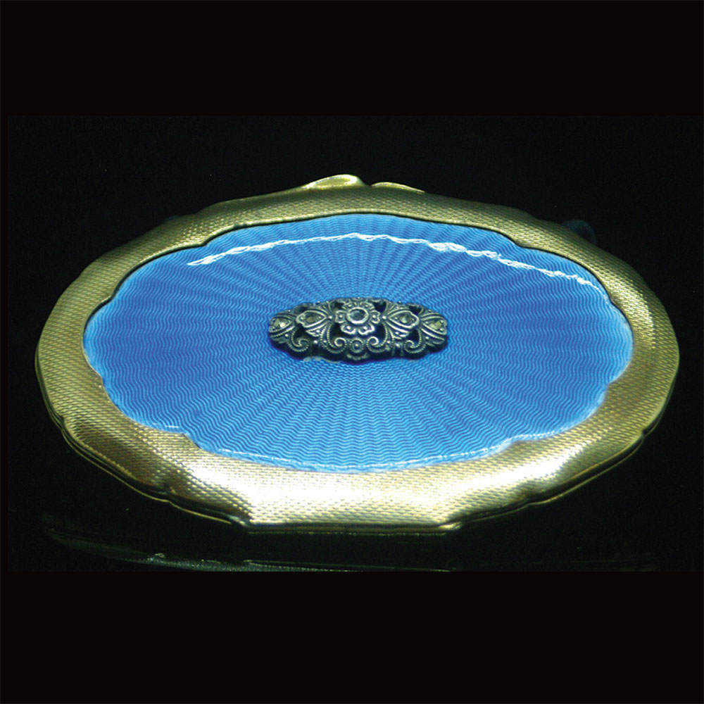 A vintage cornflower blue guilloche enamel powder compact set with a marcasite badge to the centre