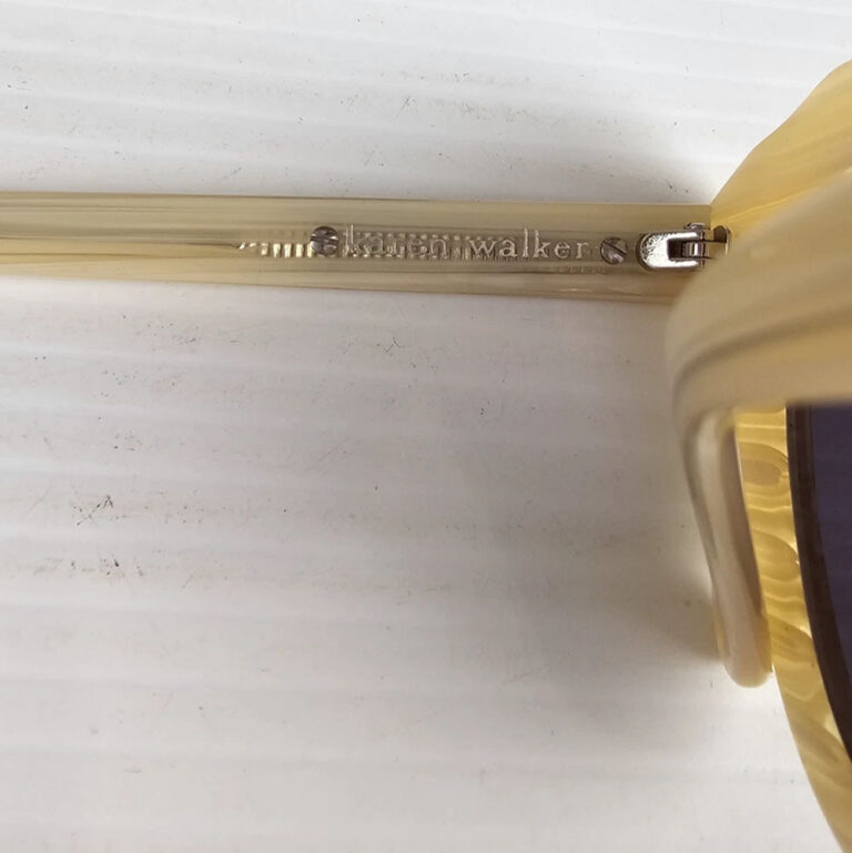 Pair of vintage Karen Walker sunglasses with a cream frame, designed in New Zealand.