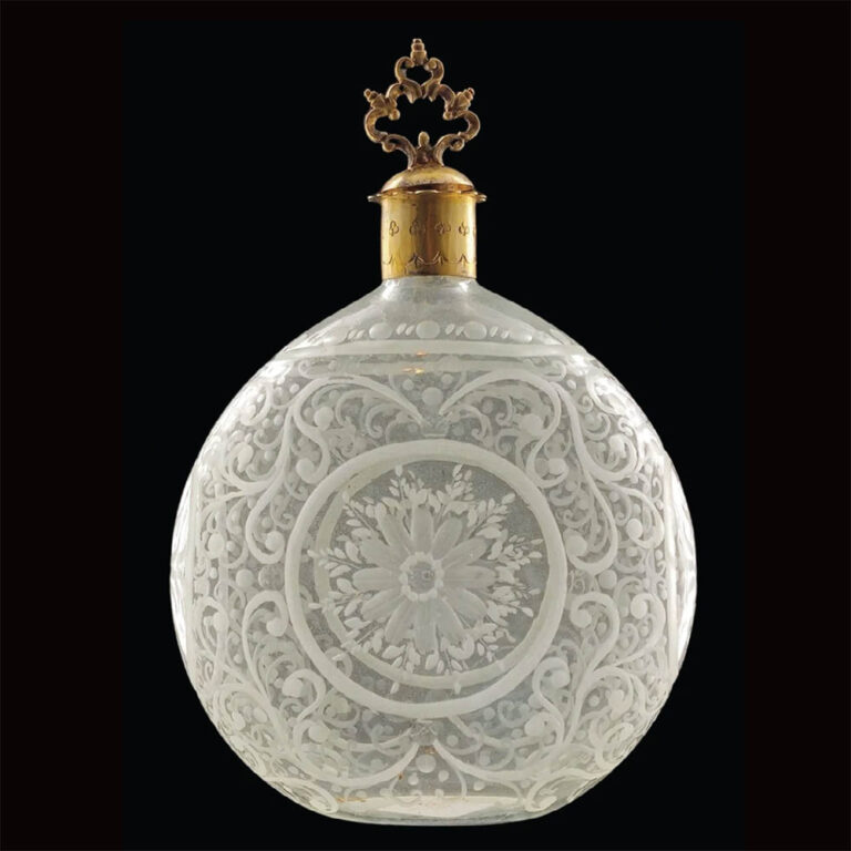 A moon-shaped blown glass decanter with elaborate wheel-cut engraving. Bohemia c.1750