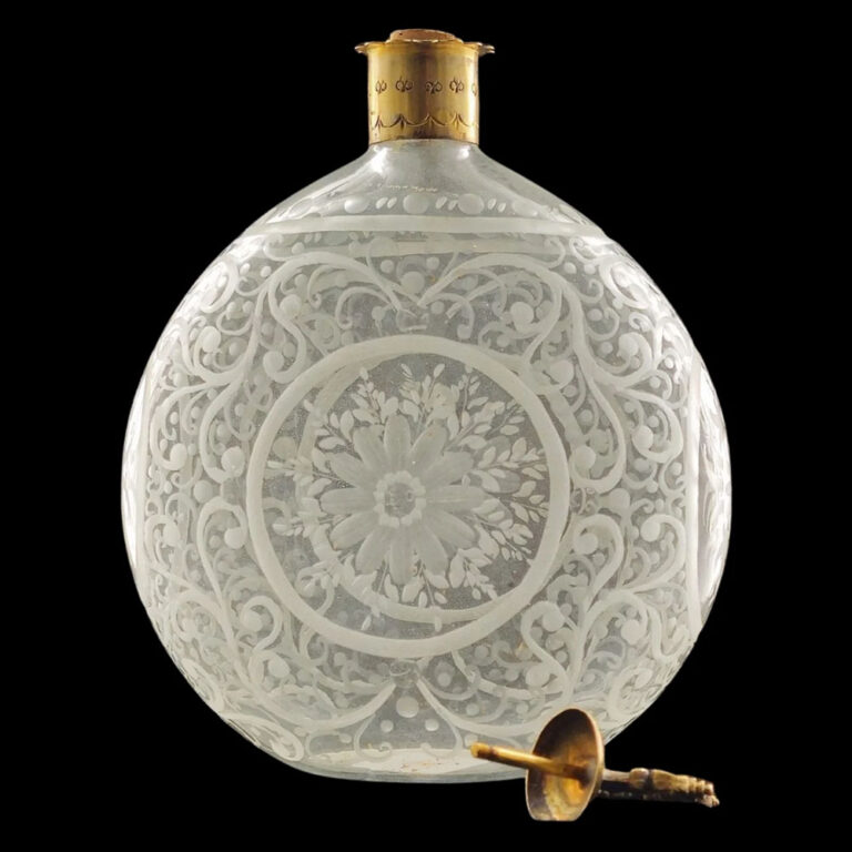 A moon-shaped blown glass decanter with elaborate wheel-cut engraving. Bohemia c.1750