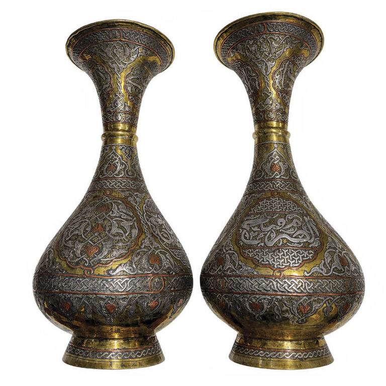A pair of antique Middle Eastern brass vases with silver inlay.