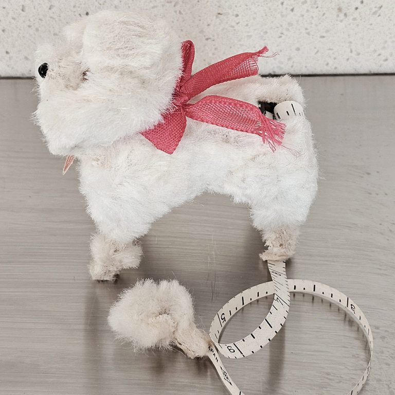 This cute vintage novelty tape measure is in the form of a dog and was made in Japan
