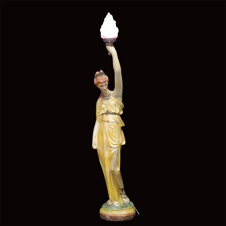 An Art Deco lady lamp with a flame shade