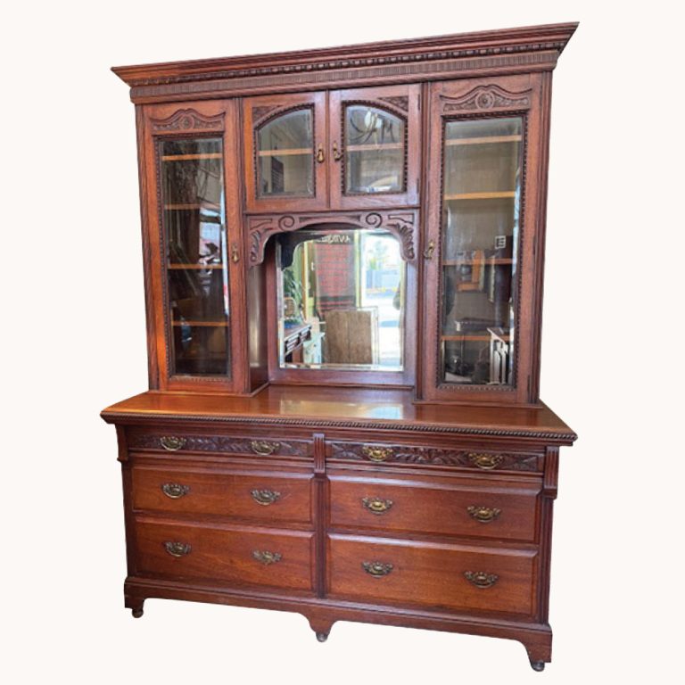 A Victorian sideboard in carved walnut with a mirror back.