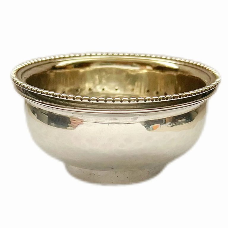 A rare and curious George III silver wine strainer