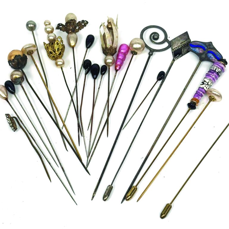 Collection of vintage hat pins, including Murano and silver.